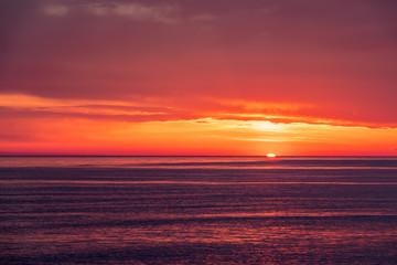 Beautiful red and orange sunset over the sea. The sun goes down over the sea.