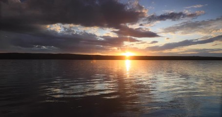 Yellowstone dark sunset over lake and forest. Beautiful high Rocky Mountain lake. Nature, serenity and peace landscape environment. Geography, geology, natural beauty, wildlife and tourism.
