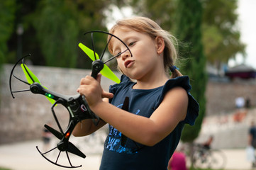 little girl in the Park launches drones