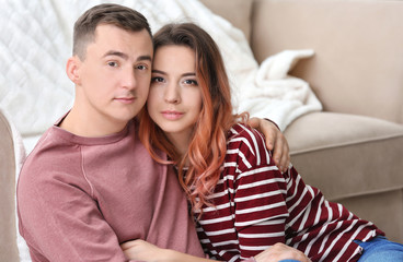 Portrait of cute young loving couple at home