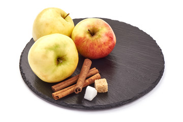 Juicy apples on a stone plate, isolated on white background