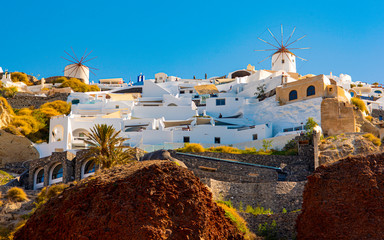 Handheld view of the coastal cliffs of Santorini as seen from a boat on the water.