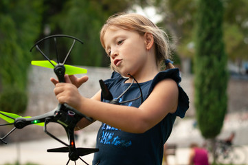 little girl in the Park launches drones