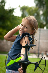 little girl in the Park launches drones