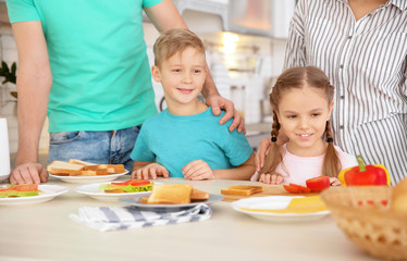 Obraz na płótnie Canvas Little children having breakfast with toasts in kitchen