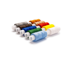 Set of multi-colored spools of cotton thread isolated, with real shadow