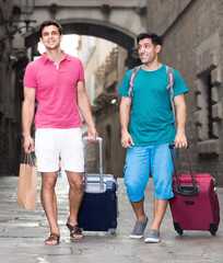 Fototapeta na wymiar Two men friends walking together with baggage