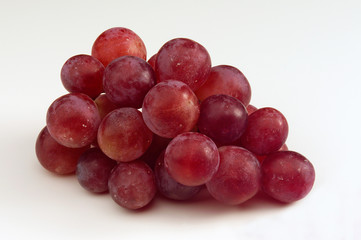 Small bunch of Red Grapes against white