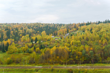 Fototapeta na wymiar landscape autumn river valley between the hills with the railway