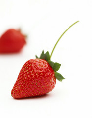 Beautiful Strawberry with stalk against white
