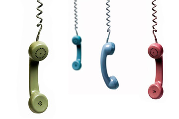 Four phones hanging from several colors isolated on a white background