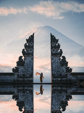 Woman Standing Between Gate To Heaven At Pura Lempuyang Temple