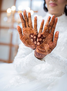 Midsection of bride showing henna design