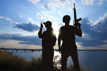 Fototapeta premium Soldiers in uniform patrolling outdoors. Military service