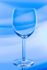 empty wine glass on blue light background