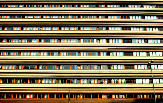 Eight floors of a building with rectangular windows.