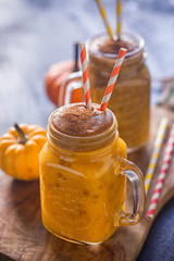 Pumpkin smoothie with cinnamon in a jar 