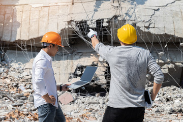 Demolition control supervisor and contractor discussing on demolish building.