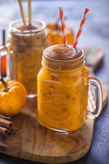 Pumpkin smoothie with cinnamon in a jar 