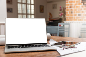 Laptop with tablet on architect desk. Business, architecture, building construction and technology concept.