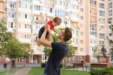 Father with adorable little baby outdoors. Happy family