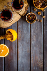 Romantic New Year with two glasses of mulled wine on dark wooden background top view frame copy space