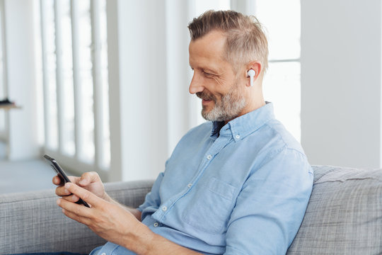 Man relaxing at home with his music