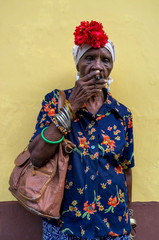 Old Cuban lady smoking a large cigar in La Havana, Cuba