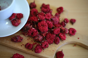 Pomegranate turkish tea in the white cup on the wooden background. Close up turkish tea.