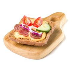 Open  faced sausage sandwich canape or crostini on a wooden serving board  isolated on white background closeup.