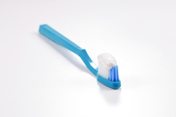 Toothbush with toothpaste on a white background.