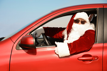 Authentic Santa Claus driving modern car outdoors