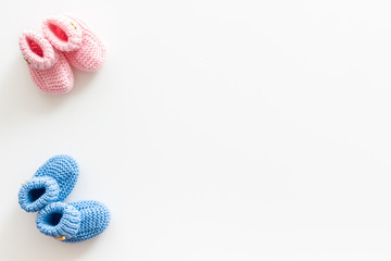 Booties for newborn boy and girl on white background top view mockup