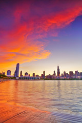 Fototapeta premium View of Chicago skyline from the shore of Lake Michigan at dusk.