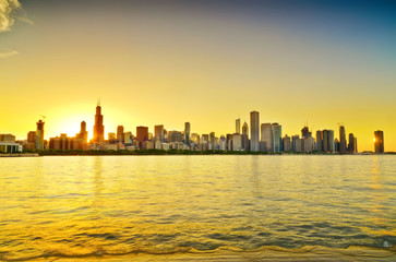 View of Chicago skyline from the shore of Lake Michigan at sunset.