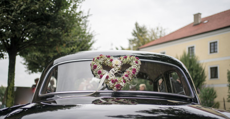 Wedding car oldtimer decorated with flower heart