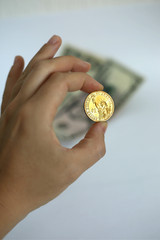 Hand holding US Dollar coin on white background in New York in the USA.