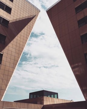 the buildings are leaning towards each other