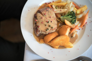 Chicken steak with wedges, vegetables and colorful pepper