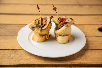typical spanish tapa se bacon and squid mushrooms