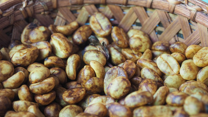 Closeup Shot of Honey Process Coffee Beans in A Bamboo Basket.  Selective Focus, Blurred Foreground and Background.