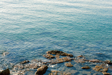 Rocky coast and calm blue sea. Calm. Inconvenient descent to the water.