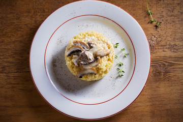 Couscous with mushrooms in cream sauce. Overhead, horizontal