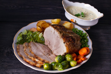 Roasted sliced ham, vegetables and sauce