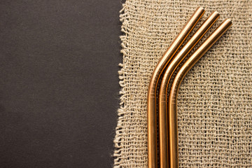 Metal straws on black background. Zero waste. Flat lay 