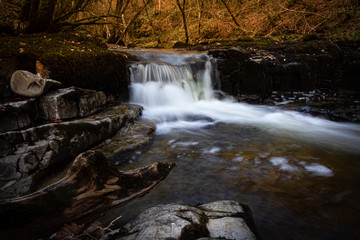 Fototapeta na wymiar Incredible long exposure of a waterfall in Brecon Beacons National Park at sunset in Wales, UK in the fall.