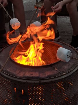 Toasting marshmallows over a fire pit
