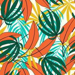 Spring-summer seamless tropical pattern with plants and leaves in shades of green and orange on a delicate background.Beautiful exotic plants. Trendy summer Hawaii print.