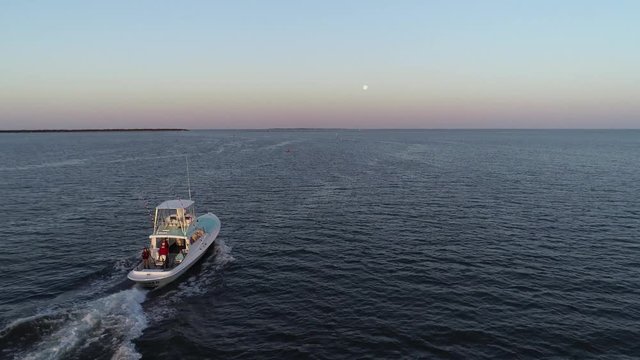 Fishing boat heading out to sea - 4k Drone