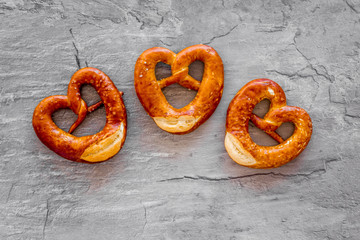 Octoberfest symbol. Fresh bavarian pretzels on grey background top view